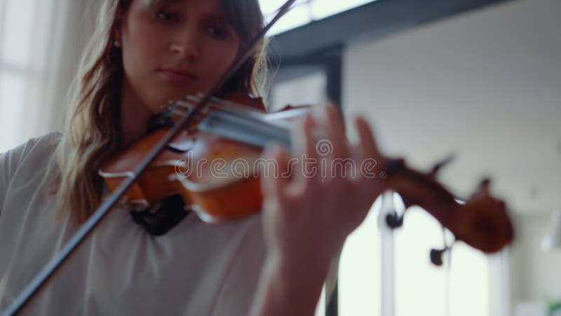 Girl practicing music on violin. Violinist creating song with string instrument