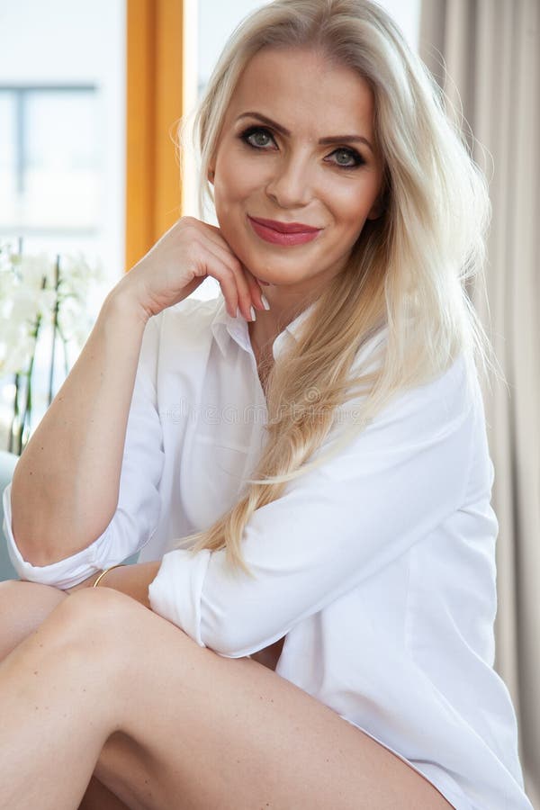 Portrait attractive blonde woman in white shirt