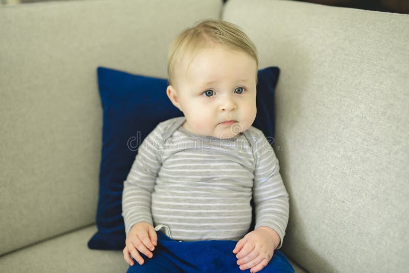 Portrait of Baby Boy Sitting on the Couch. Stock Photo Image of