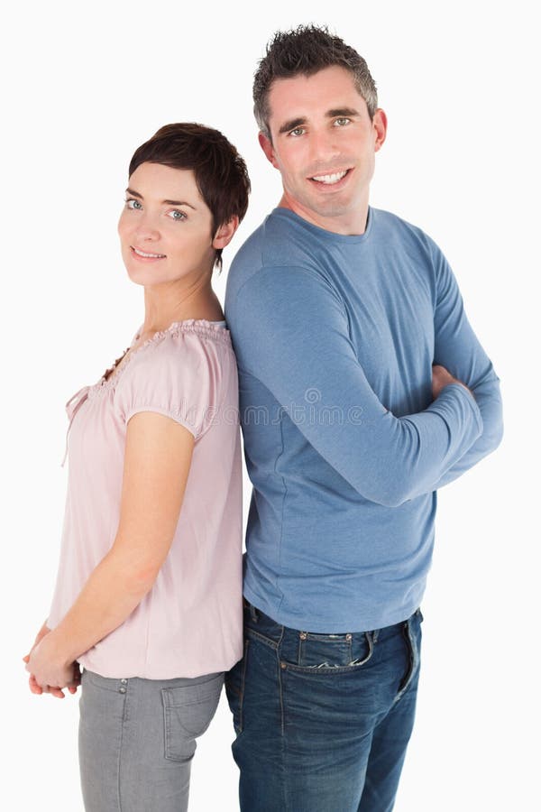 Portrait of a back to back couple against a white background