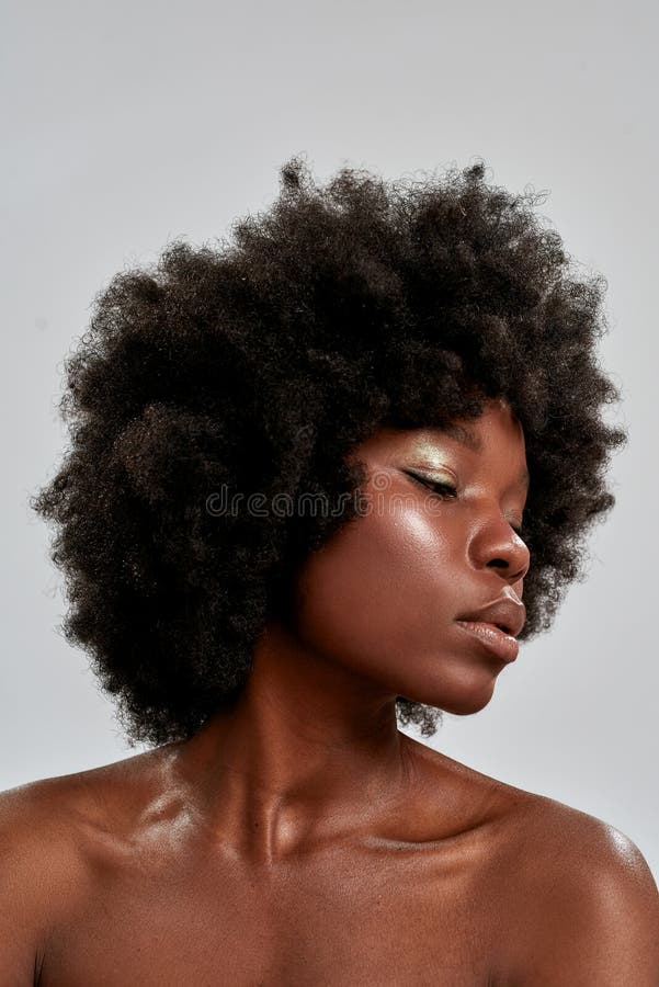 Portrait of Beautiful African American Female Model with Afro Hair and  Perfect Smooth Glowing Skin Looking Down, Posing Stock Image - Image of  groomed, closeup: 210149105