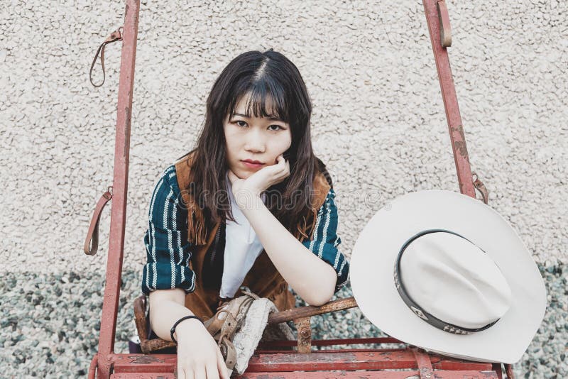 Portrait of a Beautiful Armed Chinese Female Cowgirl Stock Photo ...