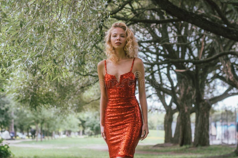 Portrait of Beautiful Girl in Red Short Dress with Sequins in Park ...