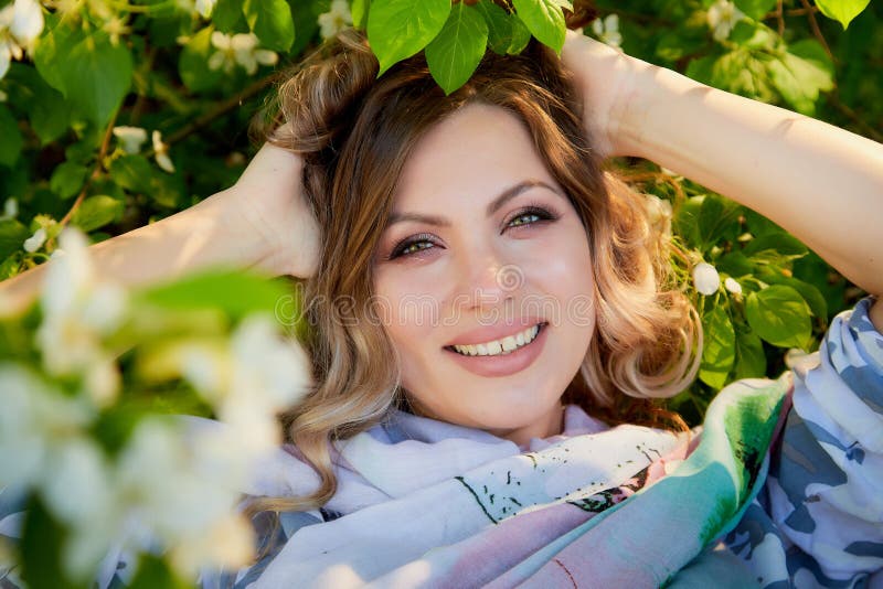 Portrait Of A Beautiful Blonde Girl With Green Eyes And Blossoming