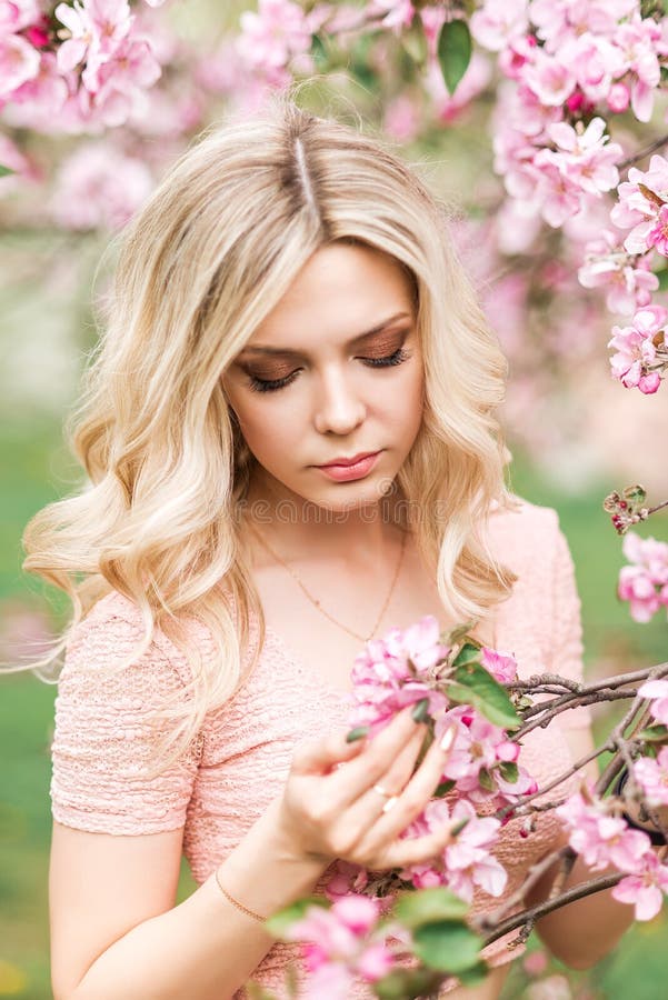 Portrait of a Beautiful Blonde Girl in a Spring Garden. Pink Apple ...