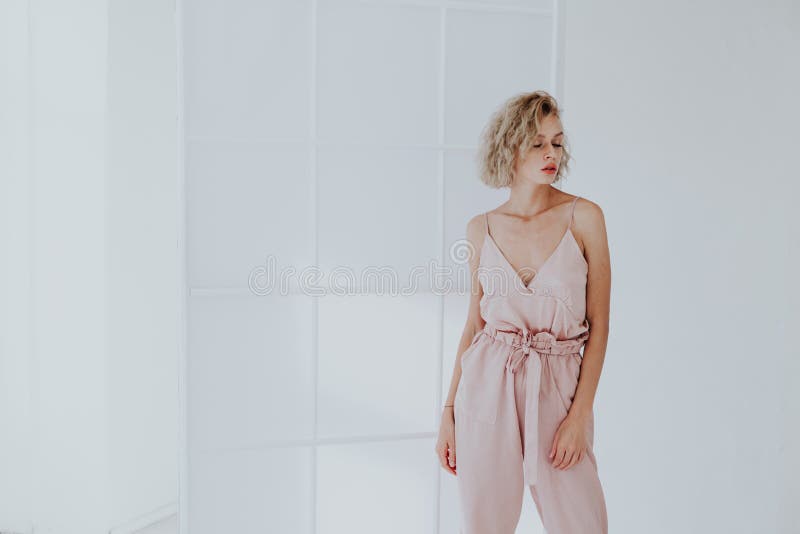 Portrait of a Beautiful Fashionable Blonde Woman in a Pink Jumpsuit ...