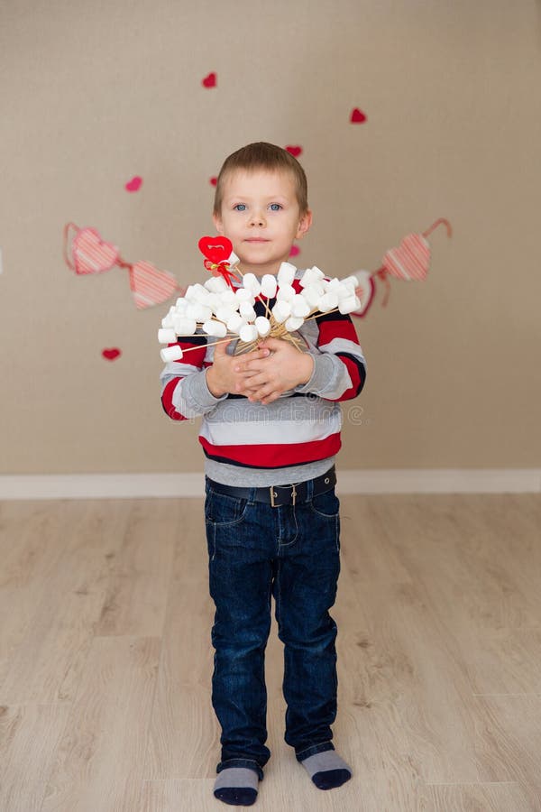 Portrait of a beautiful boy in a striped sweater and jeans.