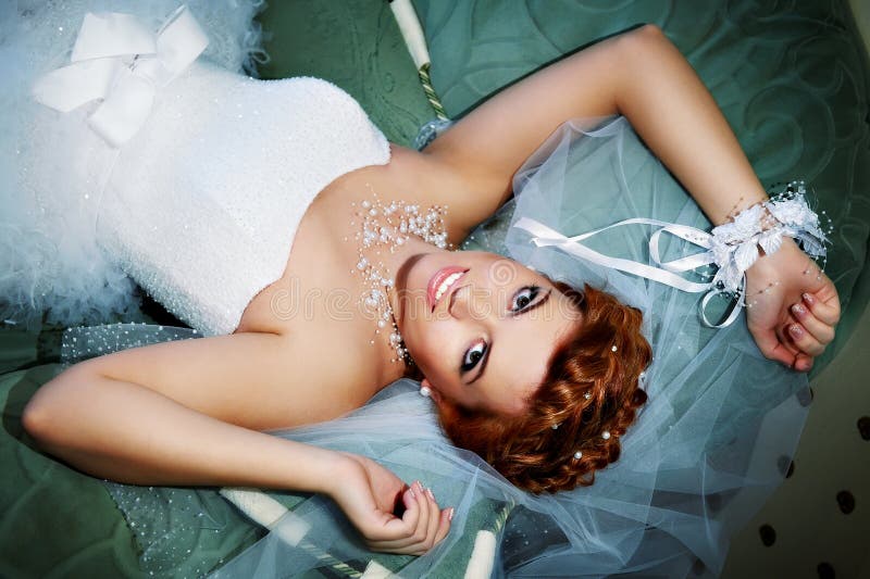 Portrait beautiful bride lying on bed