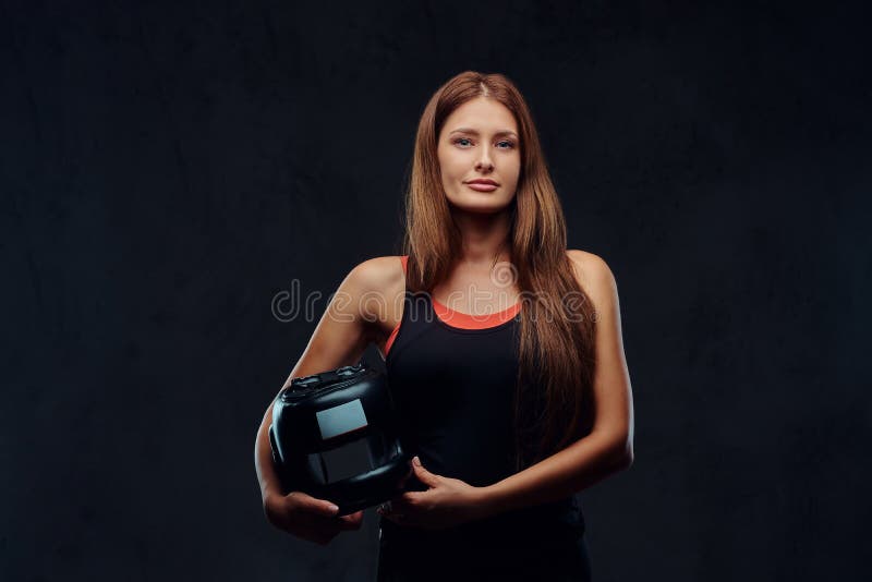 Portrait of a beautiful brunette female boxer in sportswear holds a protective helmet, looking at a camera. on stock image Portrait of a beautiful brunette female boxer in sportswear holds a protective helmet, looking at a camera. on stock image