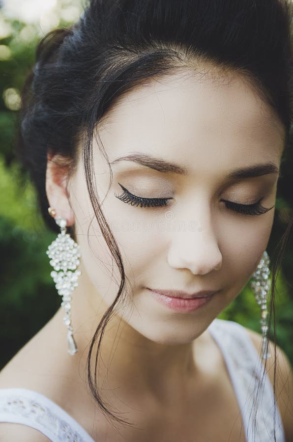 Portrait of a beautiful brunette girl with closed eyes, makeup, false eyelashes stock photography Portrait of a beautiful brunette girl with closed eyes, makeup, false eyelashes stock photography