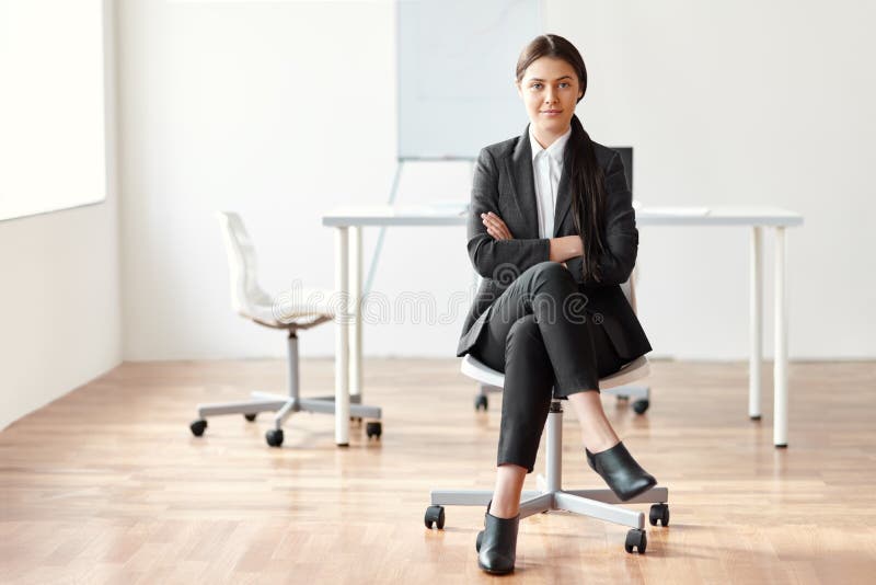 Portrait of beautiful business woman sitting on chair