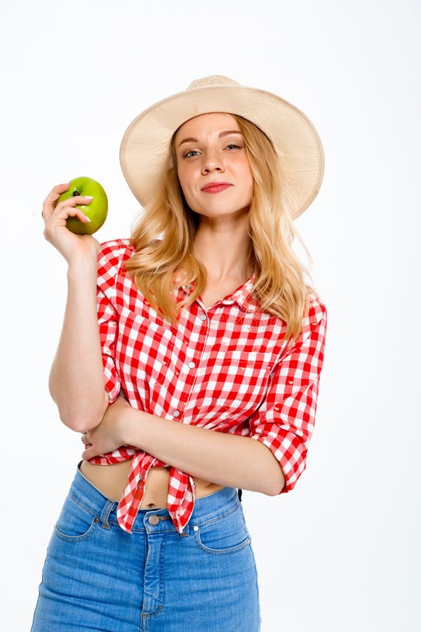 Portrait of beautiful country girl with apple over white background.