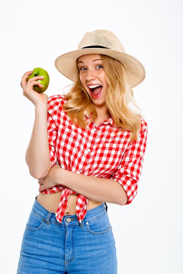 Portrait of beautiful country girl with apple over white background.