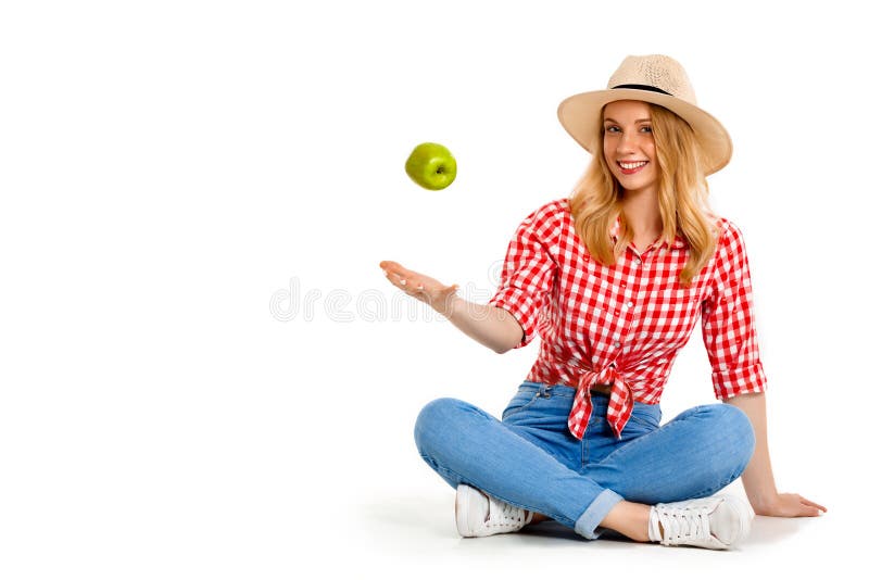 Portrait of beautiful country girl with apple over white background.