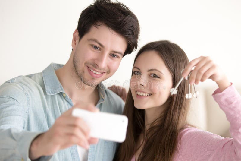 Enjoy joined. Couple hold Keys from Apartment.