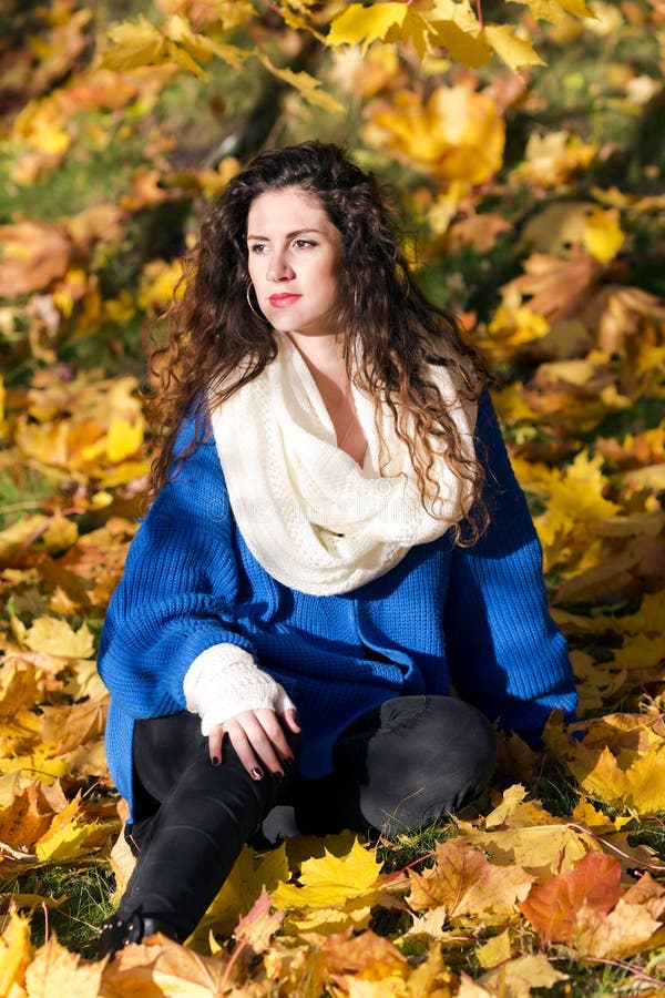 Portrait of a beautiful elegant woman in autumnal park