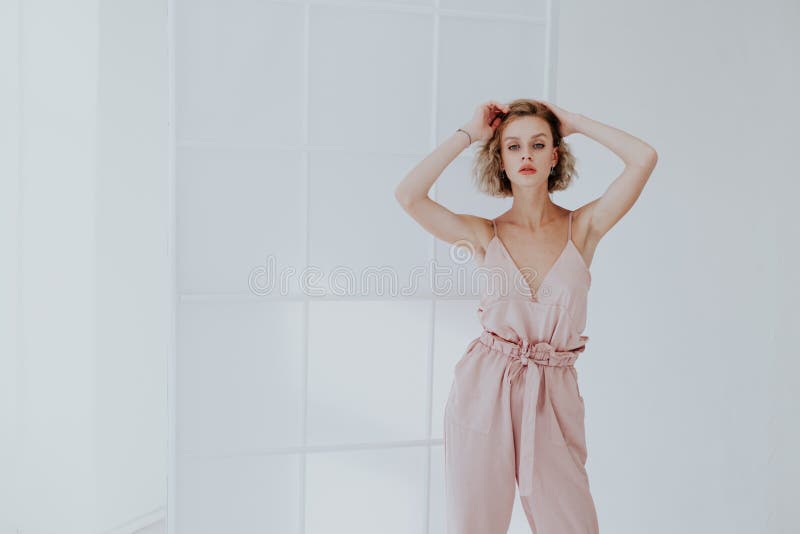 Portrait of a Beautiful Fashionable Blonde Woman in a Pink Jumpsuit ...