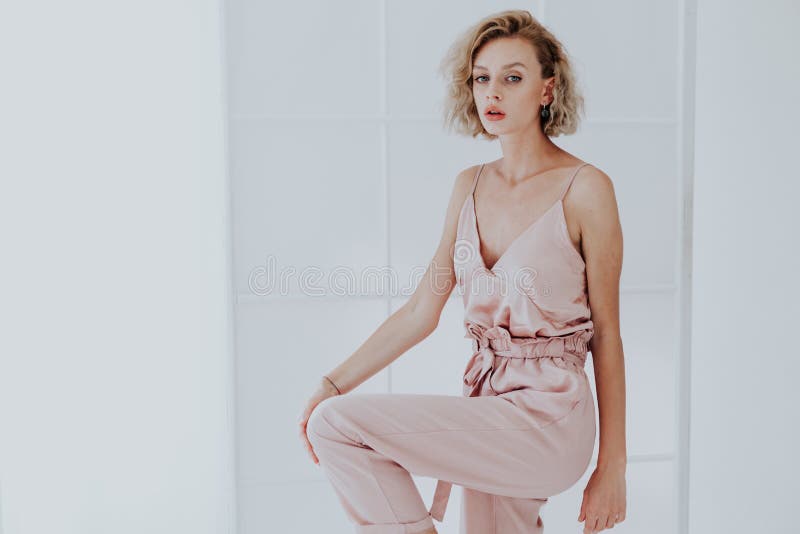 Portrait of a Beautiful Fashionable Blonde Woman in a Pink Jumpsuit ...