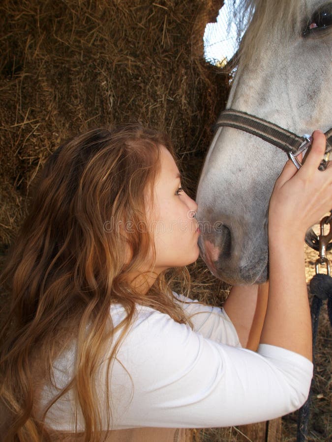 Portrait of a beautiful girl with a horse