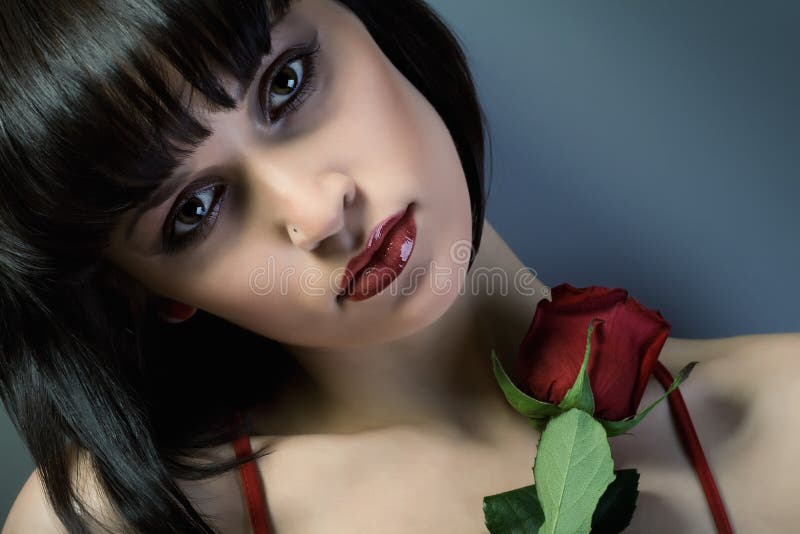 Portrait of beautiful girl with the red flower.