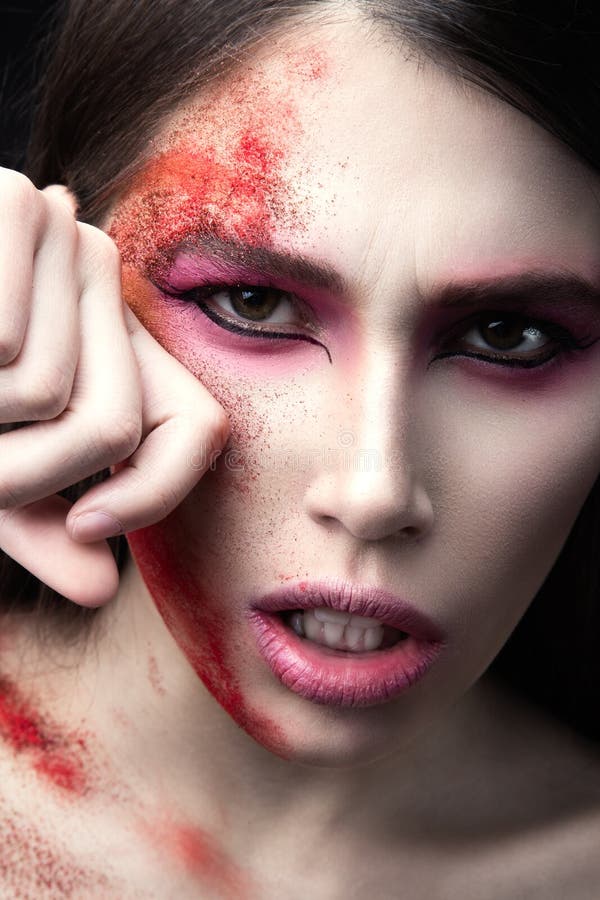 Portrait of a beautiful Girl with red paint on her face. Art beauty image. royalty free stock image Portrait of a beautiful Girl with red paint on her face. Art beauty image. royalty free stock image