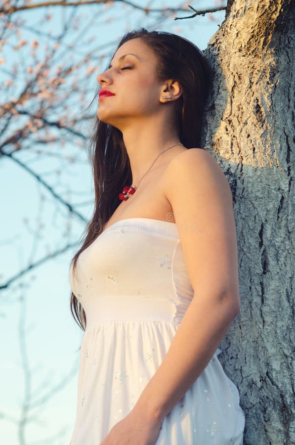 Portrait of the beautiful girl standing in apricot spring orchard stock photos Portrait of the beautiful girl standing in apricot spring orchard stock photos