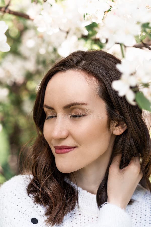 Portrait of beautiful girl, woman with closed eyes near blooming Apple tree, spring time stock photos Portrait of beautiful girl, woman with closed eyes near blooming Apple tree, spring time stock photos