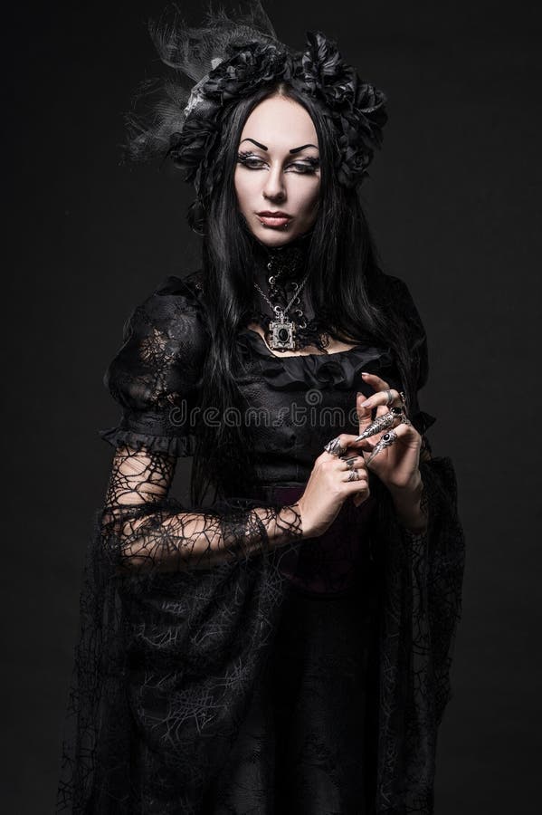 Portrait of beautiful Gothic woman in dark dress