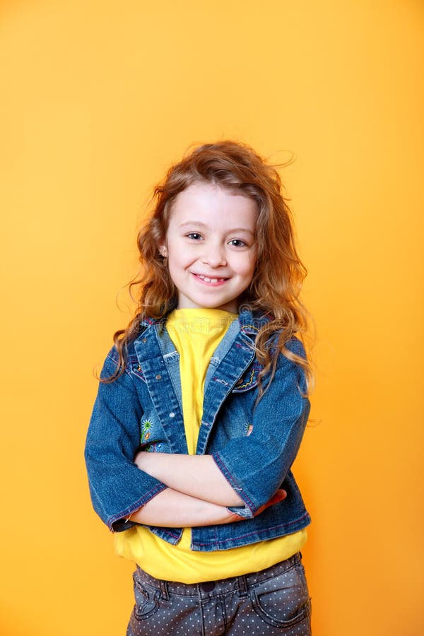 Portrait of Beautiful Happy Little Girl on Orange Studio Background ...