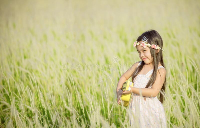 Portrait of beautiful happy smiling girl to meadow in nature on sunny day