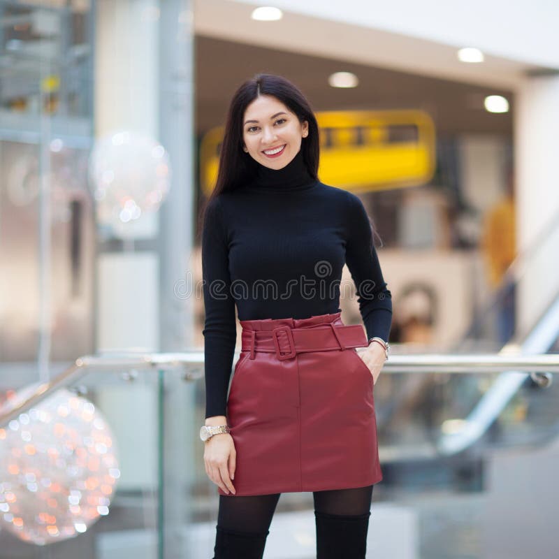 Portrait of beautiful happy stylish woman walking in city shopping center. Fashion woman lifestyle.