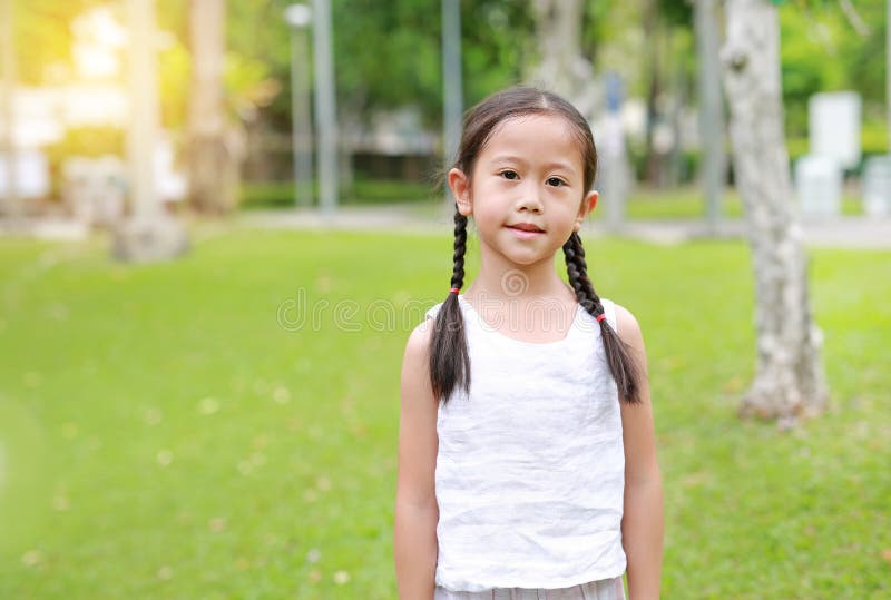 Portrait Of Beautiful Little Asian Child Girl With Two