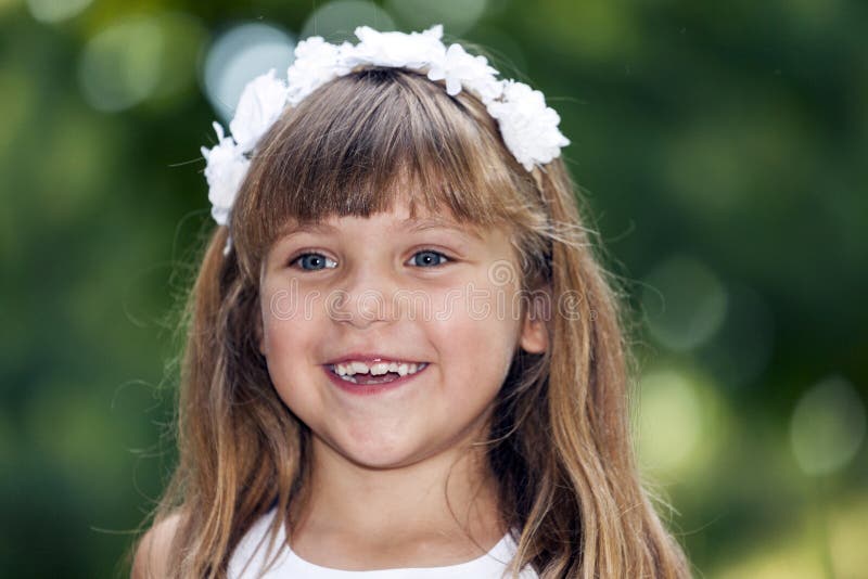 Portrait of a Beautiful Little Girl with Big Blue Eyes and Blossoms in ...