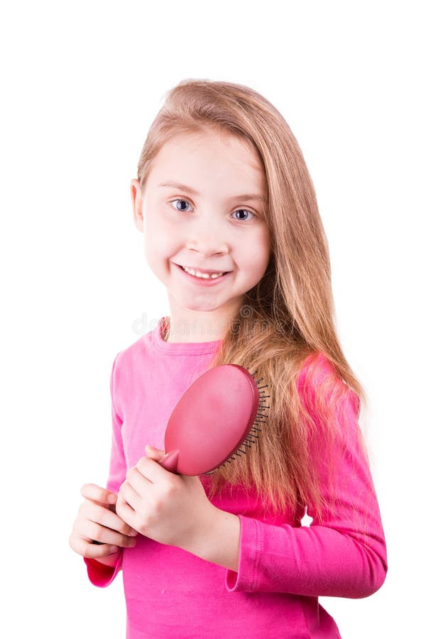 Portrait of a beautiful little girl brushing her long hair. 