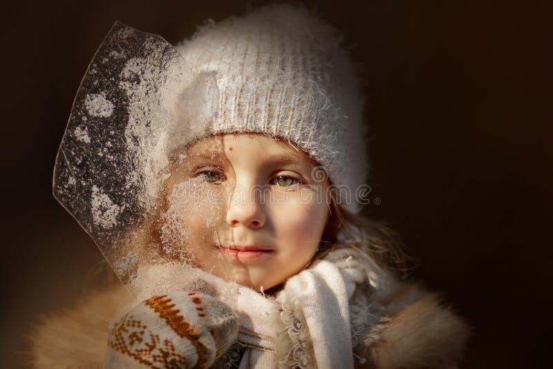 Portrait of beautiful Little girl with ice winter forest