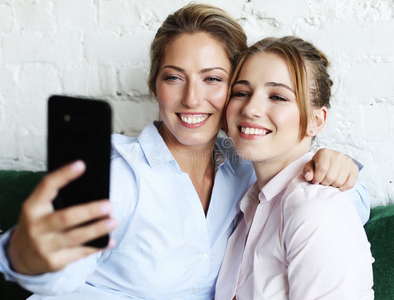 Mature Mother and Her Daughter Making a Selfie Using Smart Phone Stock ...