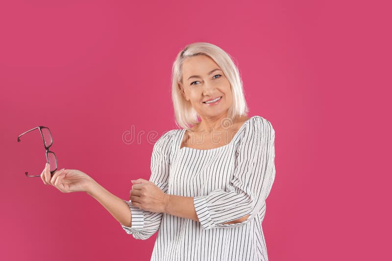 Portrait Of Beautiful Mature Woman With Glasses On Background Stock