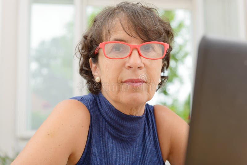 Portrait Of A Beautiful Mature Woman With Red Glasses