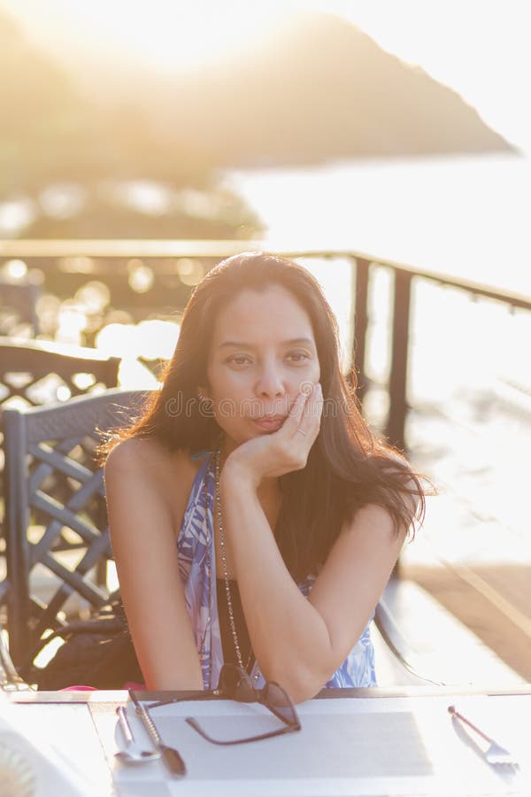 Portrait Of Beautiful Middle Age Asian Woman Sitting In Restaurant During Sunset Stock Image