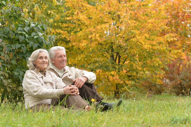 Portrait of a beautiful middle-aged couple in the autumn park