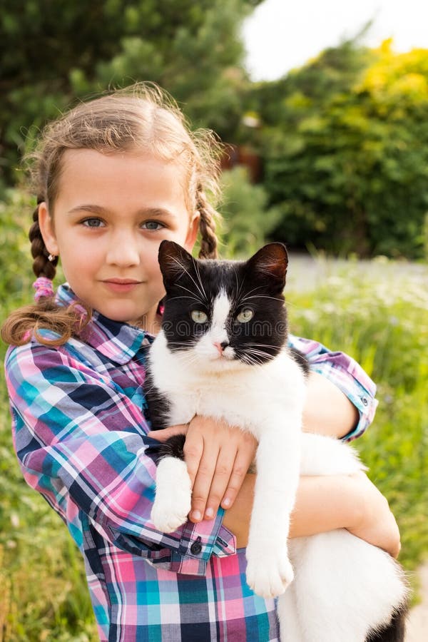 Mixed Breed Of Cat In Child Hands Embrace Of Little Russian Girl stock photos Mixed Breed Of Cat In Child Hands Embrace Of Little Russian Girl stock photos