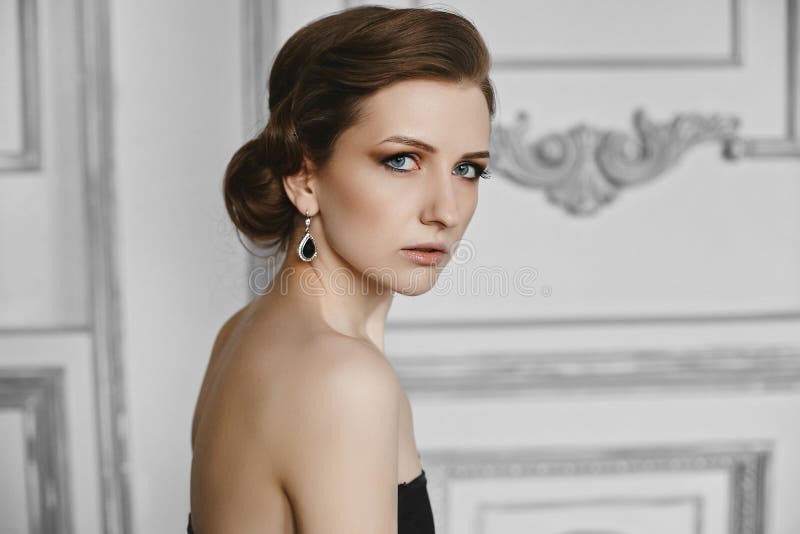 Portrait of beautiful model woman with trendy hairstyle and evening professional makeup. Side view of fashionable girl stock image Portrait of beautiful model woman with trendy hairstyle and evening professional makeup. Side view of fashionable girl stock image