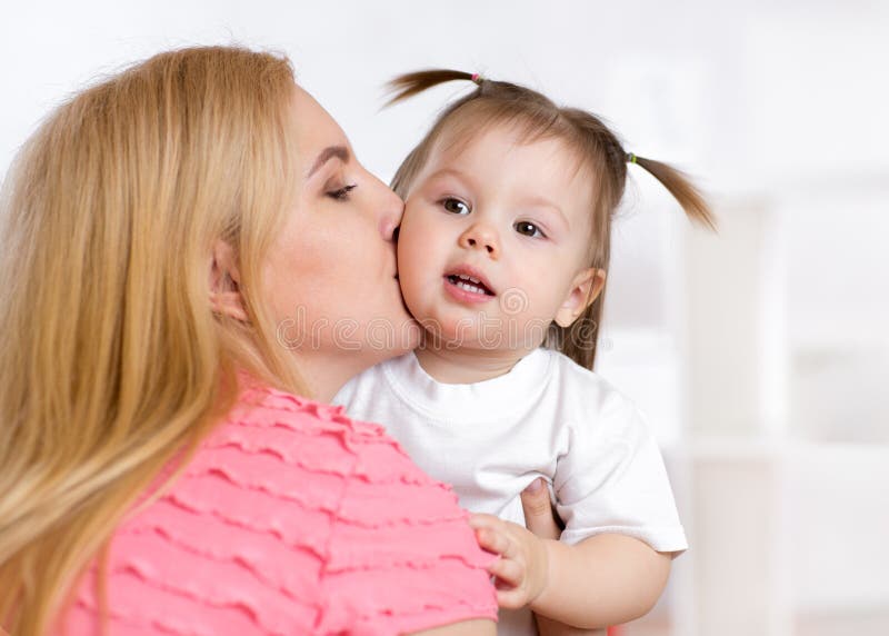 Portrait of beautiful mother kissing her child royalty free stock photography Portrait of beautiful mother kissing her child royalty free stock photography