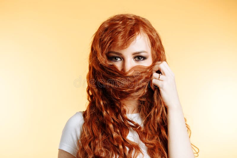 Portrait of beautiful redhead girl with long hair