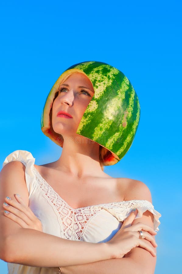 Portrait of beautiful young woman model with water-melon on head