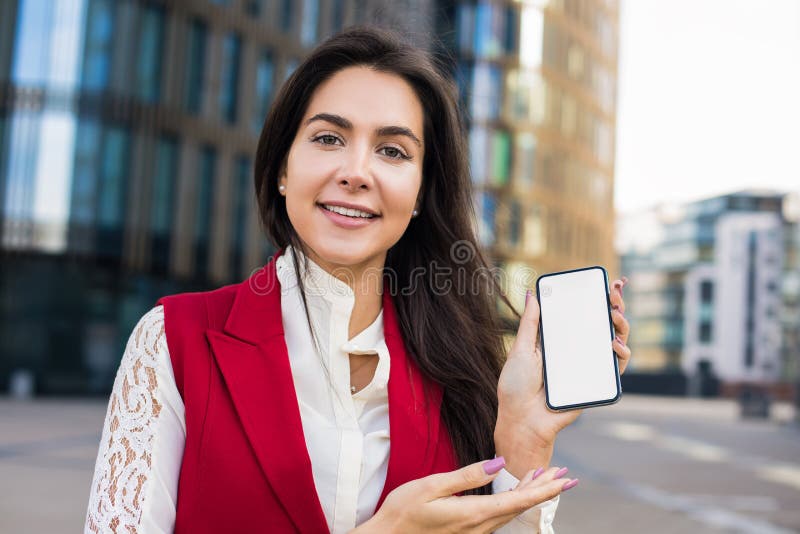 Portrait of a beautiful smiling woman professional business worker looking in camera and holding in hand mobile phone stock images Portrait of a beautiful smiling woman professional business worker looking in camera and holding in hand mobile phone stock images