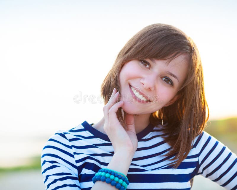 Portrait of the beautiful teen girl near the sea