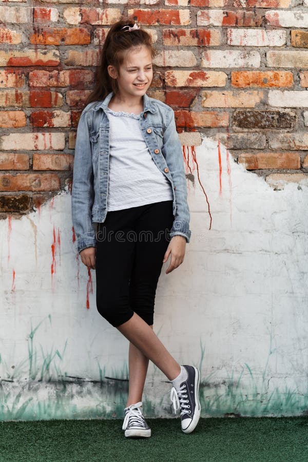 Portrait Of A Beautiful Teenage Girl Posing Against A Brick Wall Stock Image Image Of Emotion