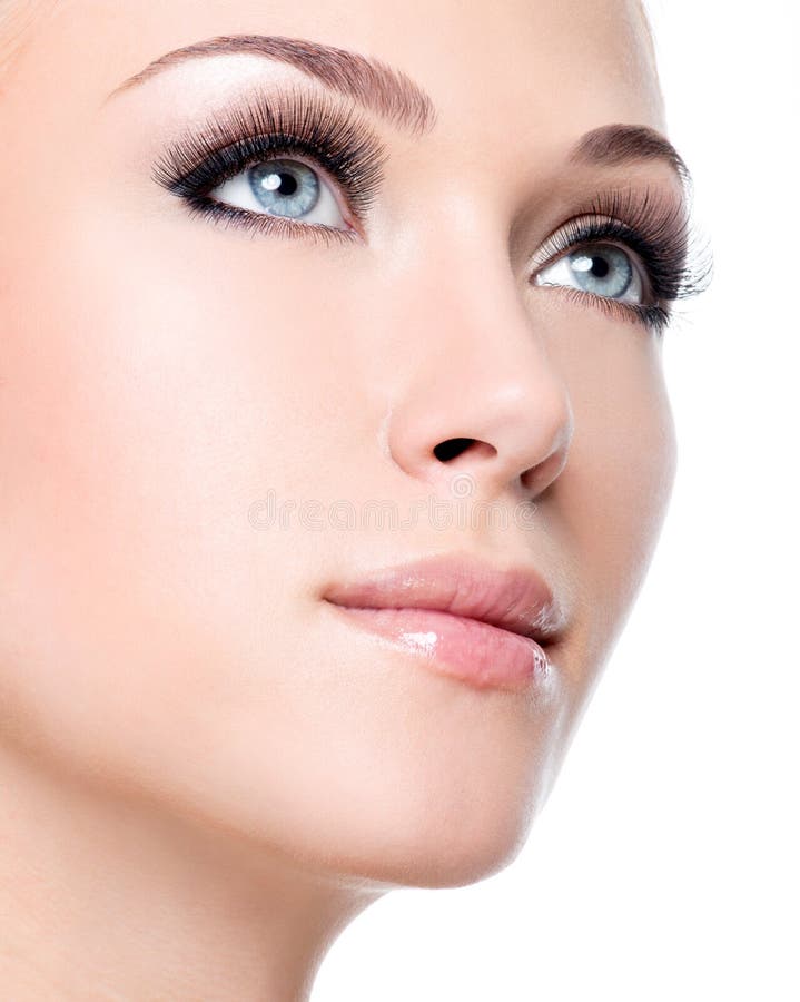 Portrait of beautiful white woman with long false eyelashes