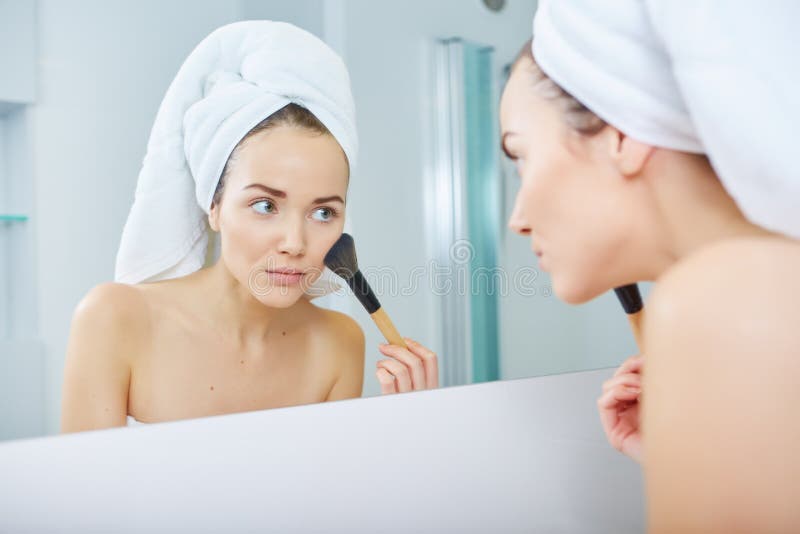 Portrait of beautiful woman applying eyeshadow